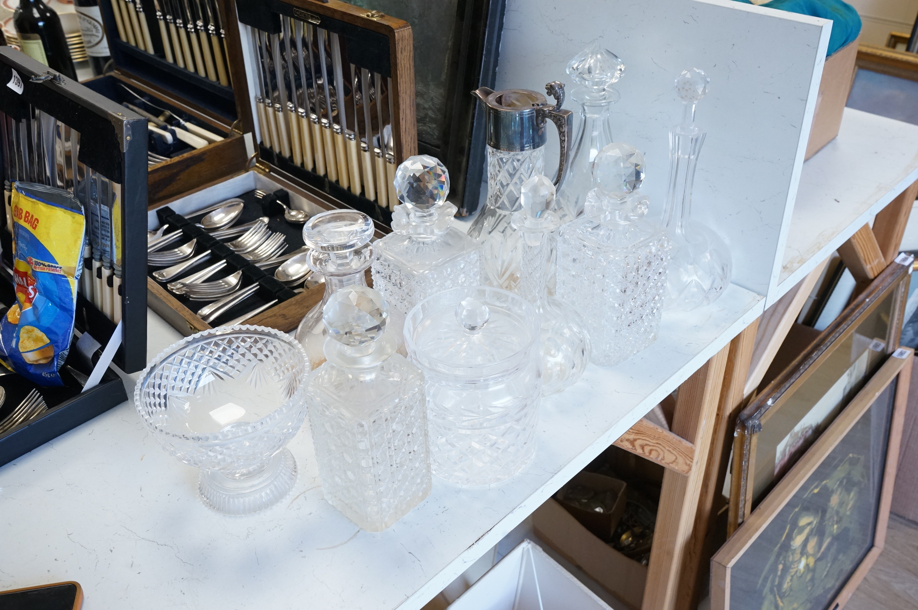 A collection of various cut glass to include decanters and a small pedestal bowl, largest 30cm high